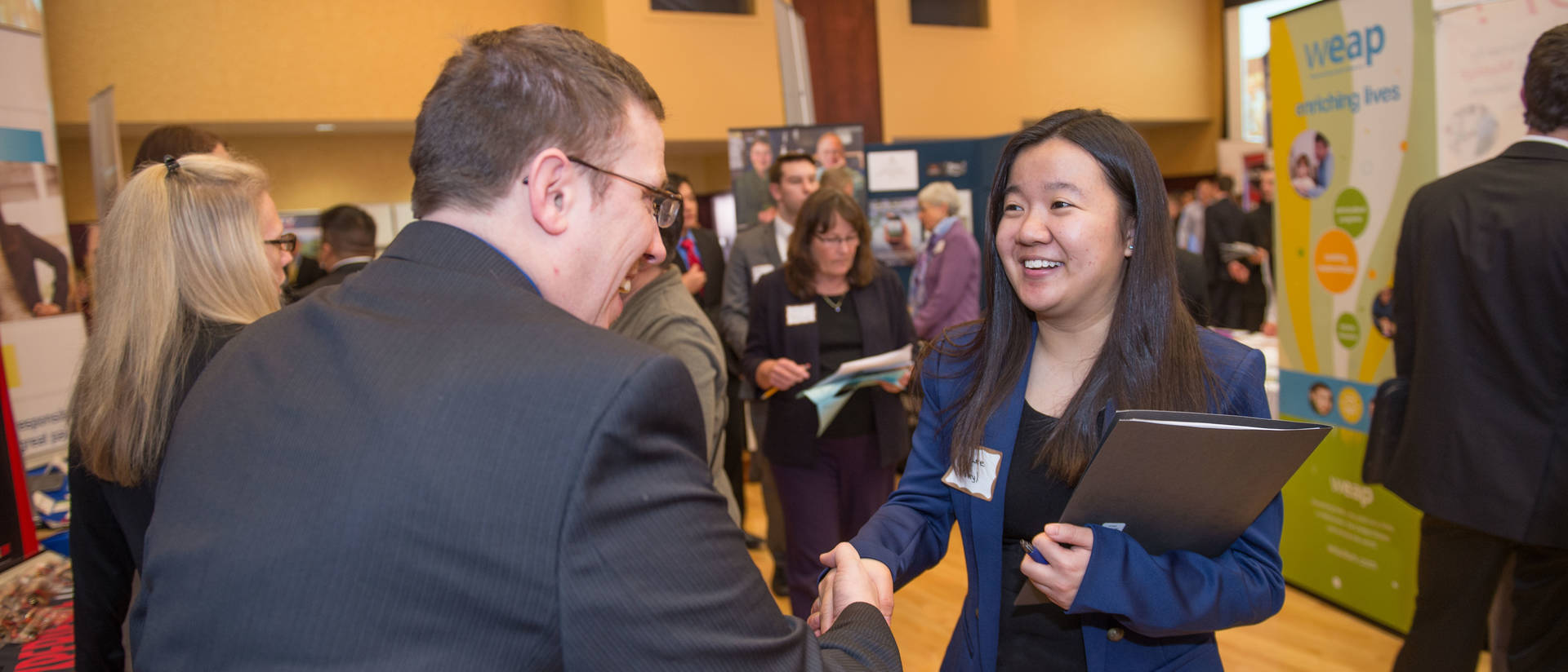 Student shaking hands at Career fair