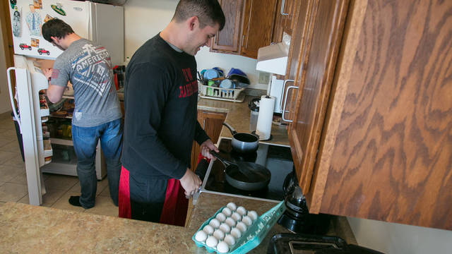 Two male students cooking in residence hall kitchen at Barron county.