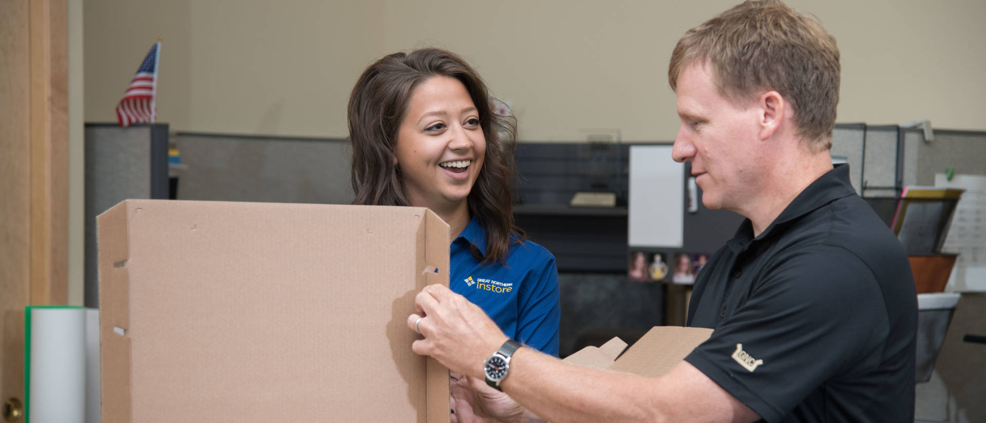 Woman and man working together to fold box