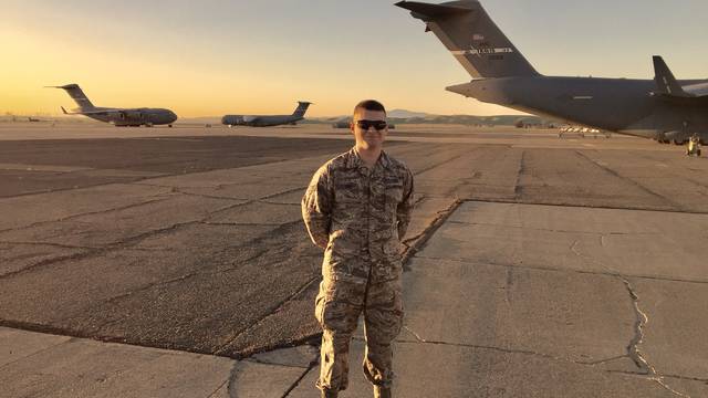 Senior Tyler Bee on the tarmak with Air Force planes