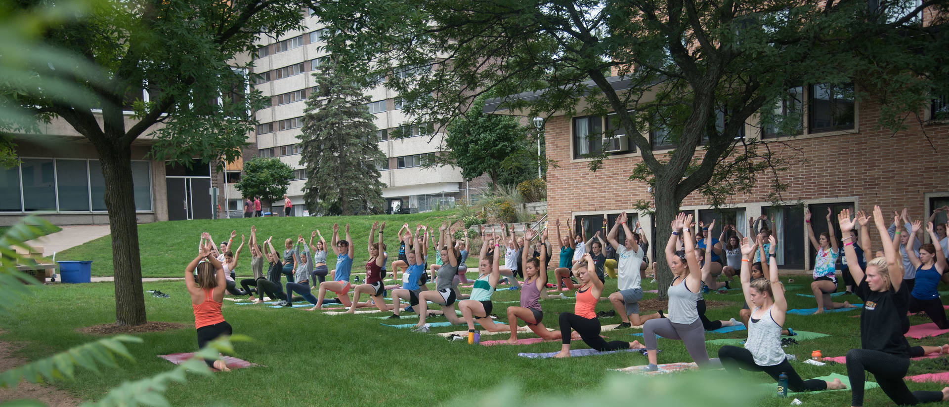 Outdoor yoga class behind Katherine Thomas residence hall 