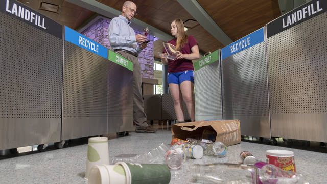 Dr. Scott Clark and senior Lily Strehlow are working to educate new students about how to properly separate their trash so it doesn’t harm the environment.