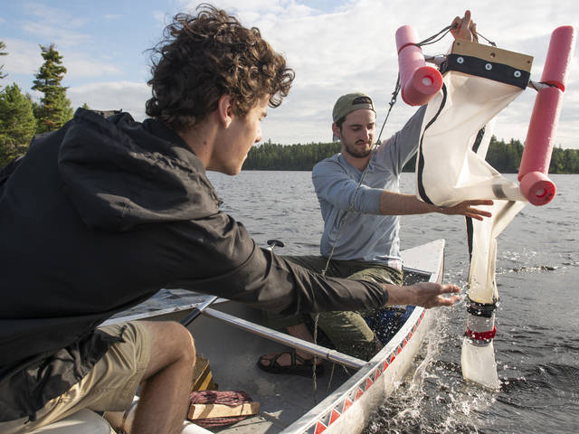 UW-Eau Claire students Reed Kostelny (left) and Thomas Adams are part of a research team that found microplastics in earthworms, water and soil in the Boundary Waters.