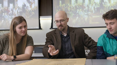 Blugolds Makenna Goretski (left) and Zach Janssen (right) are studying current political events in classes that focus on the U.S. Constitution, which are taught by Dr. Eric Kasper (center).