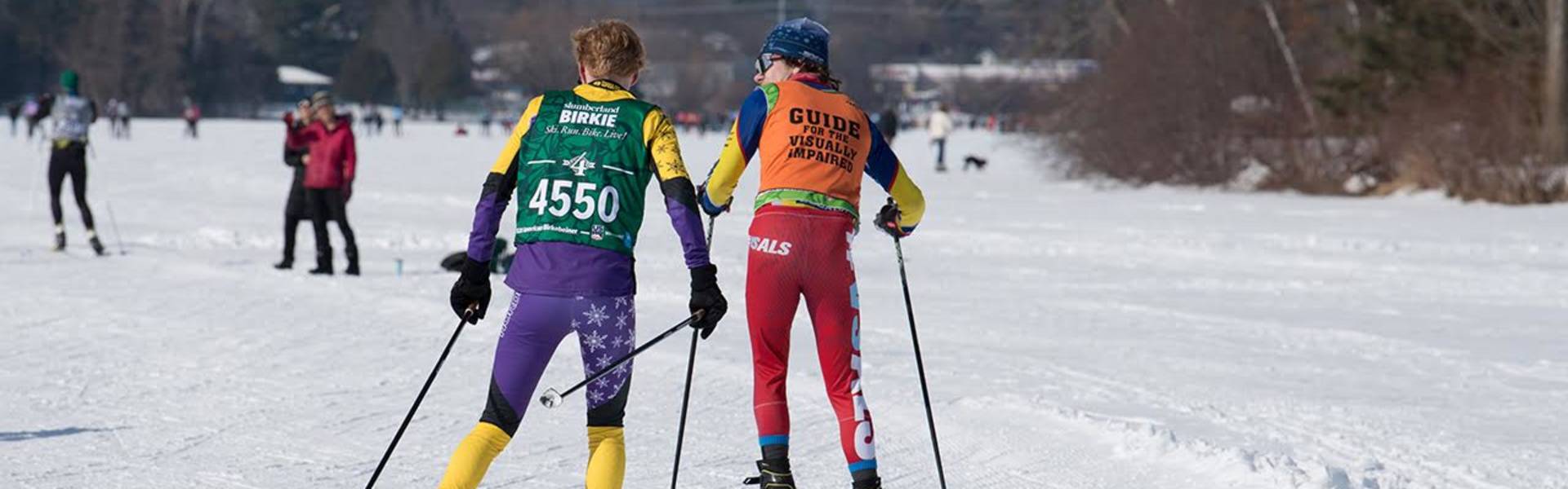 Wyatt Pajtash guiding visually impaired during a race