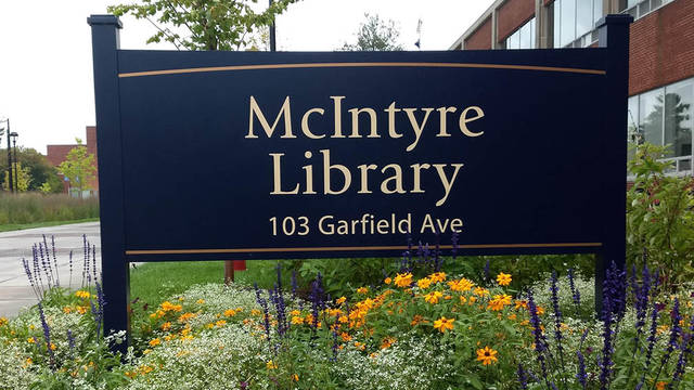 Flowers around McIntyre Library sign