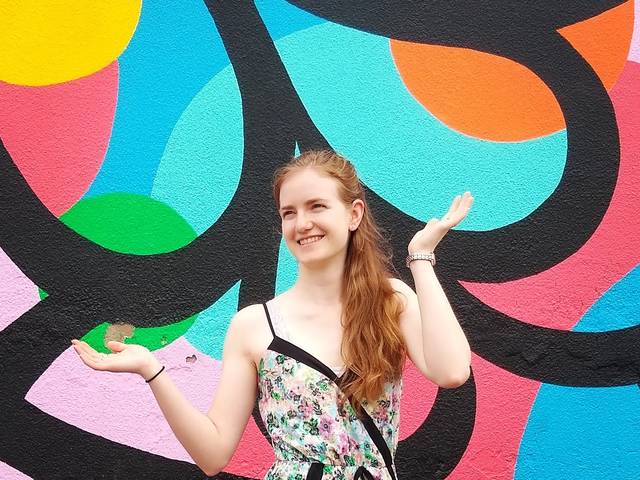 Laura Wilson with a colorful wall