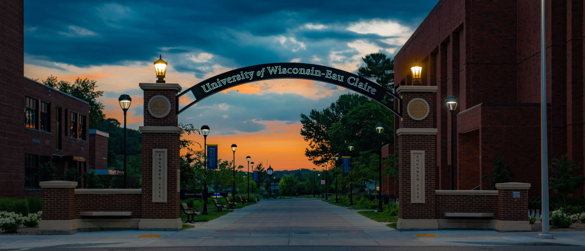 An evening picture of the UW-Eau Claire entrance gate with arch.