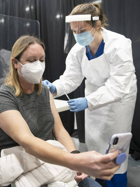 Nursing student giving vaccination in Zorn Arena