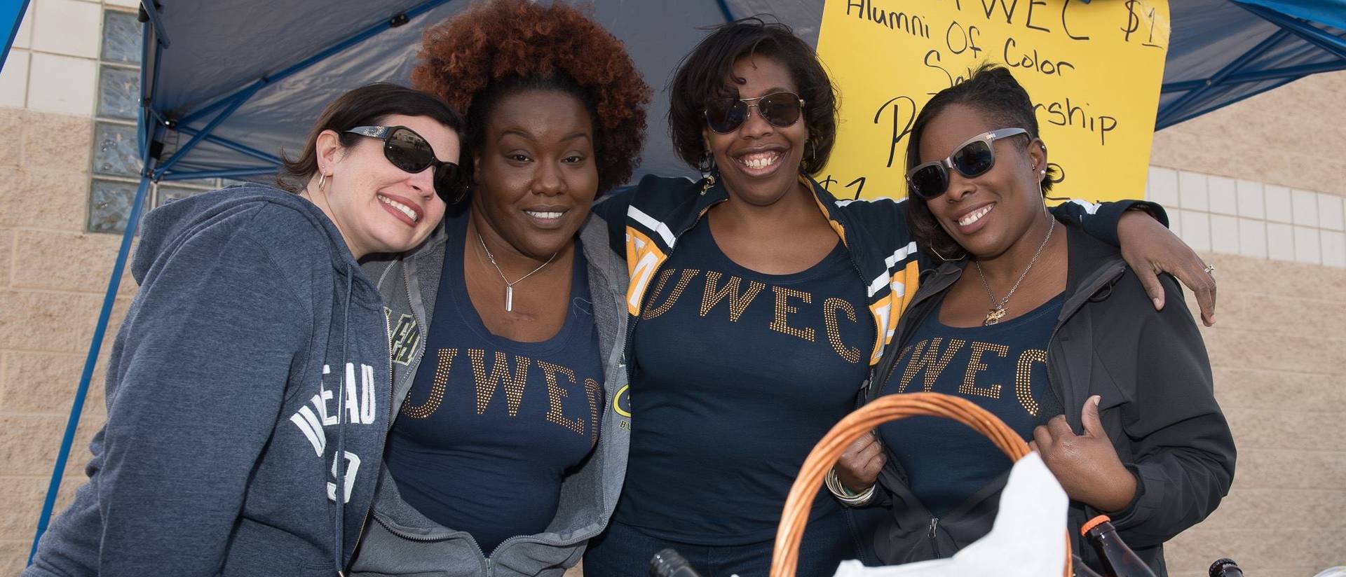 Members of the Alumni of Color Network operate a raffle at the 2015 Homecoming game to raise money for the organization’s Social Justice and Inclusion Scholarship.