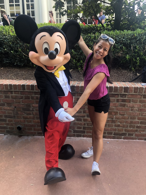Ryann Swanson with Mickey Mouse during her Disney College Program internship.