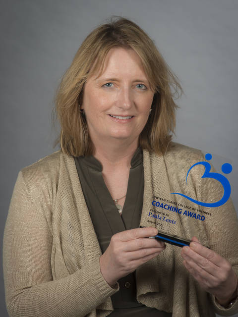 Dr. Paula Lentz happily poses with a College of Business Employee Recognition Award