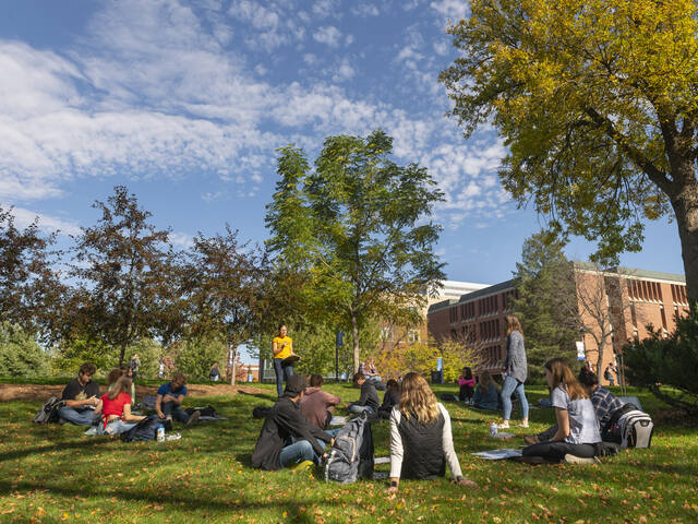 Campus mall with students in fall