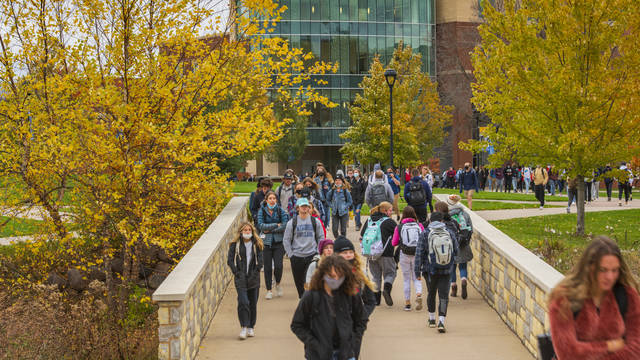 Campus mall in fall with students