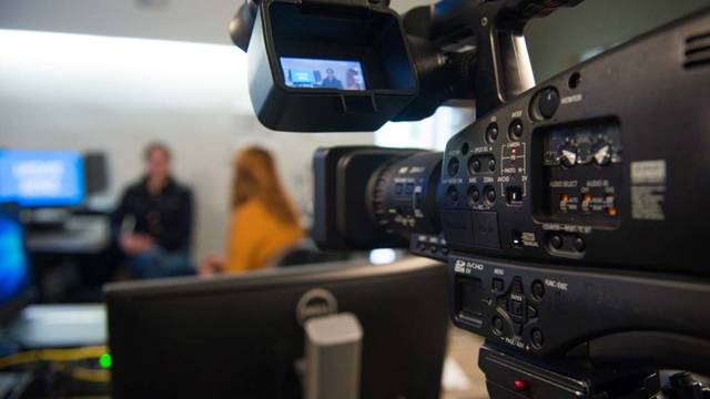 Photo of a camera recording a student interview