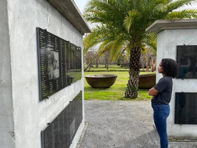 Female student looking at memorial wall at southern plantation