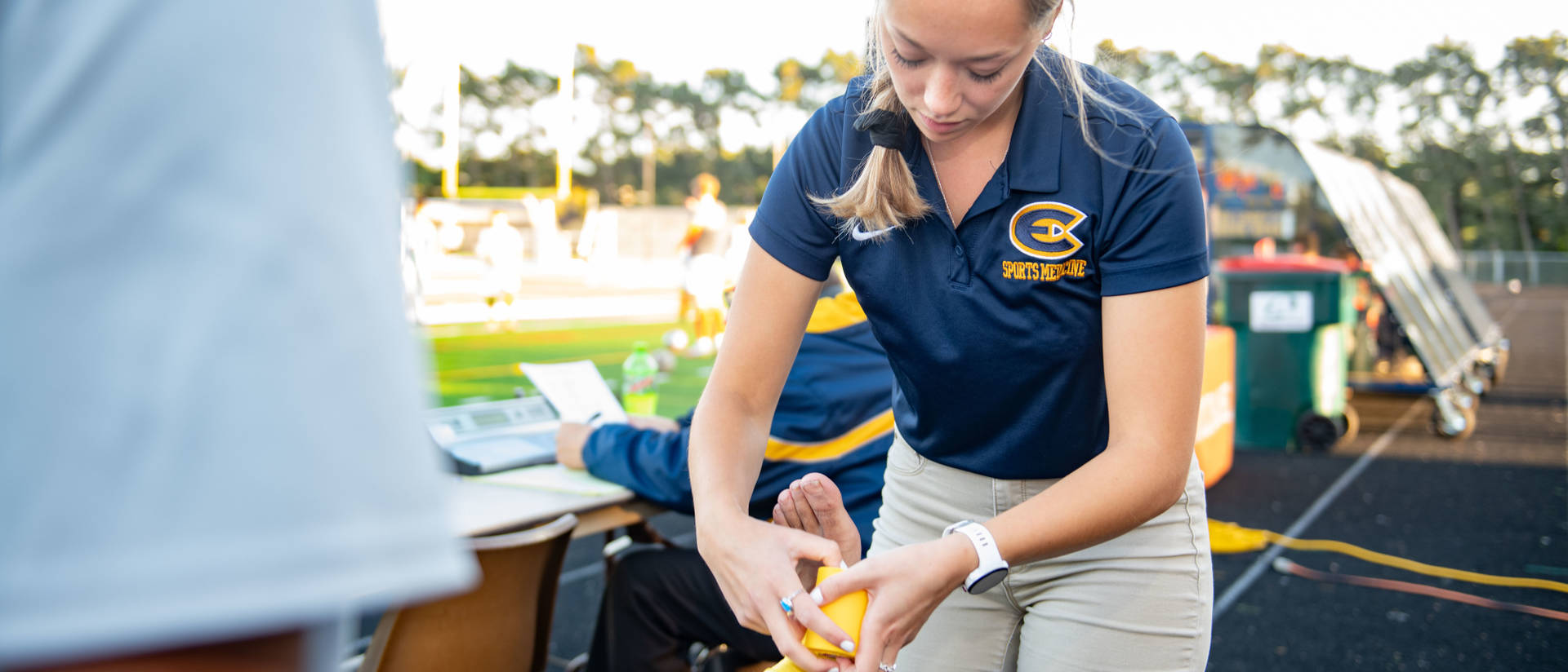 Student taping an ankle during a UWEC soccer game