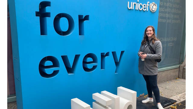 UW-Eau Claire student Kristina Tlusty stands in front of UNICEF sign