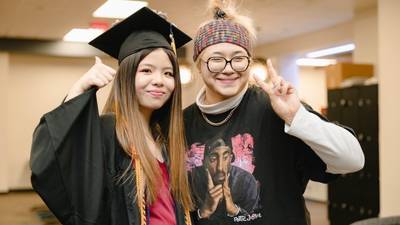 two people smiling at camera. graduation