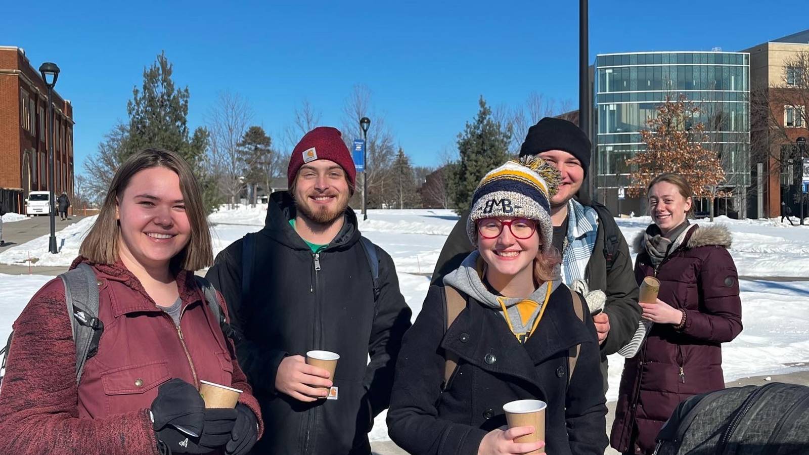 students smiling outside in winter