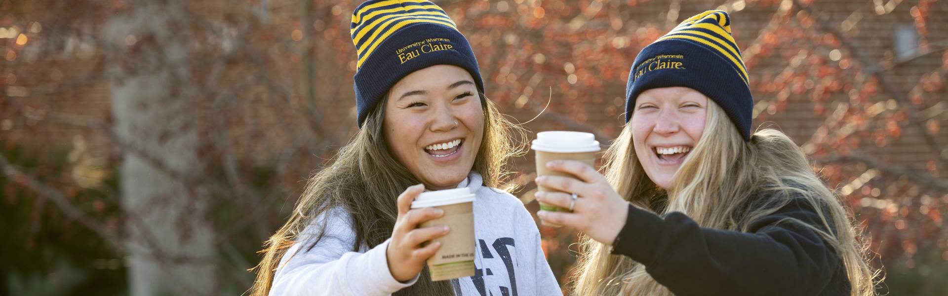 Two Blugolds holding coffees