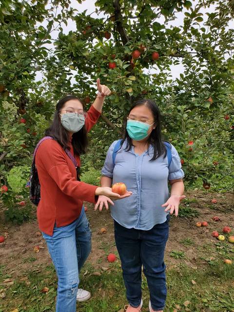 Yunyi Haung, left, and Ziyan Yang enjoyed apple picking in the Chippewa Valley. (Submitted photo)