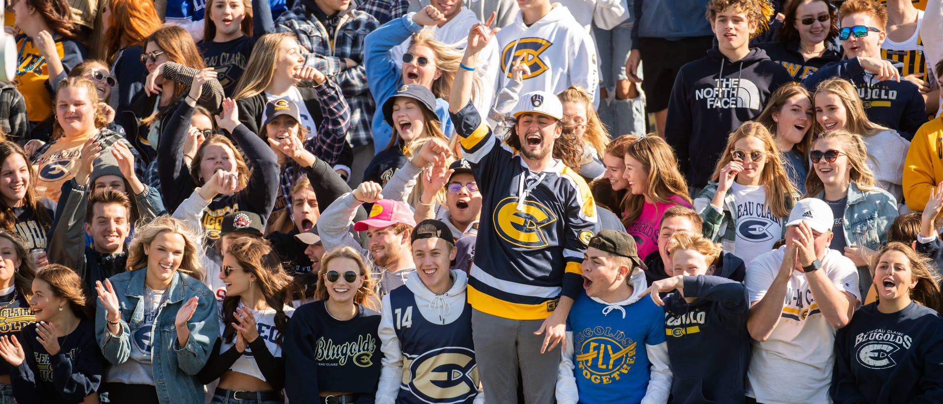 Blugold fans cheer on the football team in the stands at Carson Park