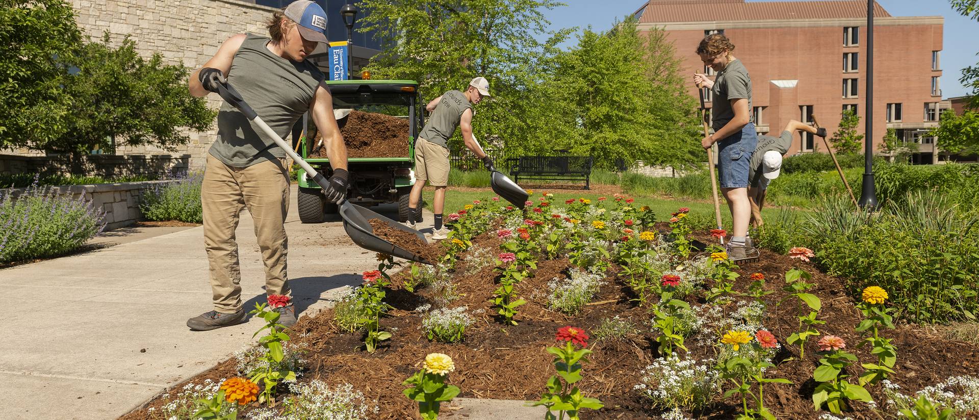 UW-Eau Claire grounds crew working on a flower bed.