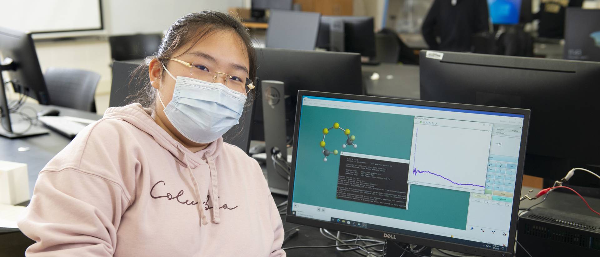 Ziyan Yang poses with a demonstration of her computational research into better battery materials.