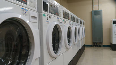 Washers and dryers in a laundry room.