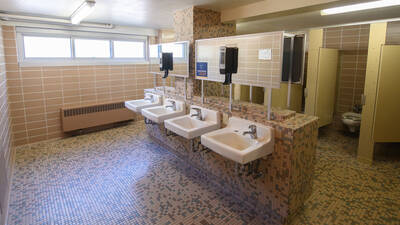 Horan Hall bathroom with sinks and toilet stalls.