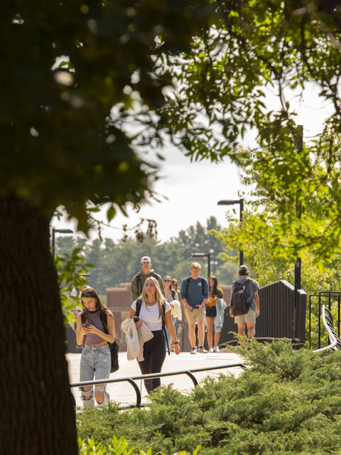 Students walk over the footbridge on their first day of class