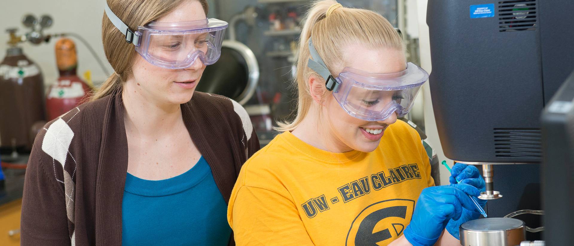 Dr. Liz Glogowski (left) works with materials science student Liz Stubbs on measuring the viscosity of polymer samples as part of the UW System Applied Research Grant project. Different viscosities of the polymers are important for enhanced oil recovery.