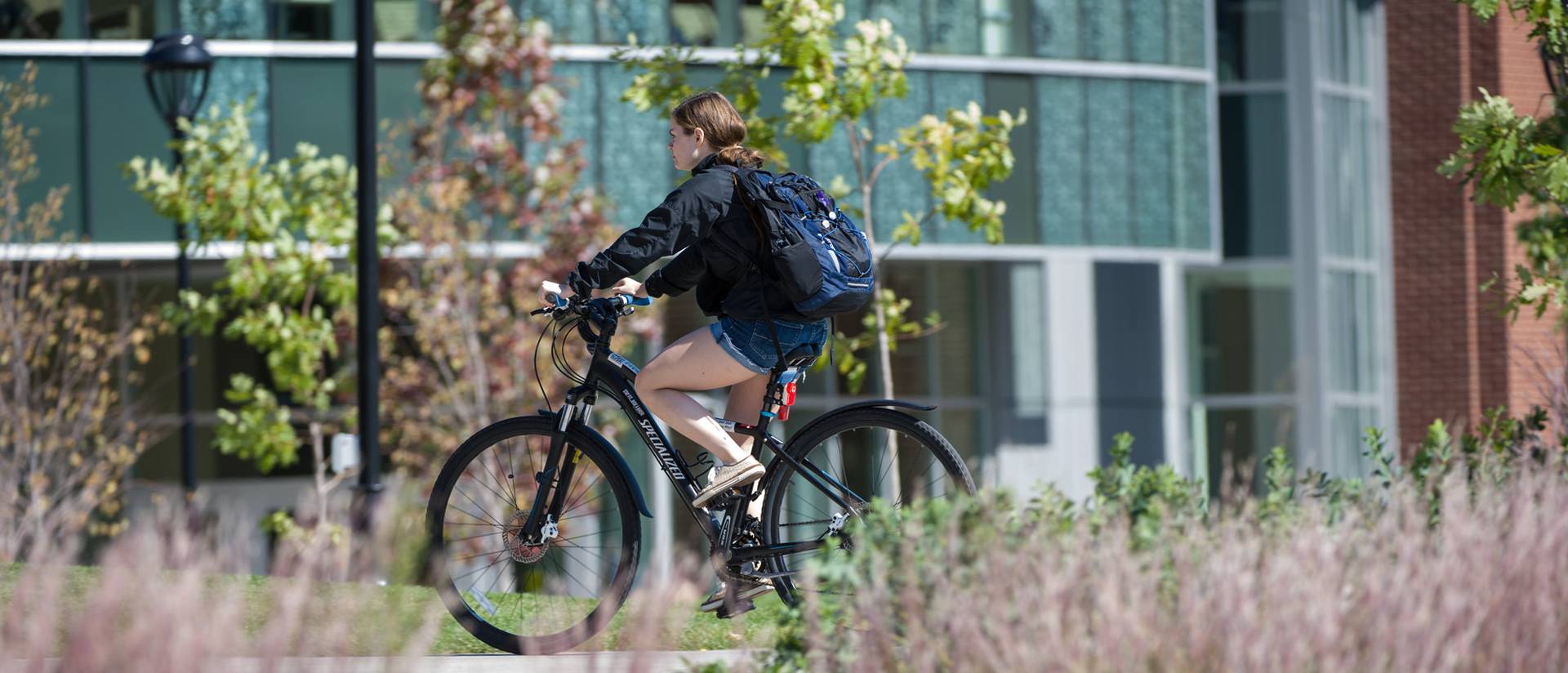 Student biking across campus