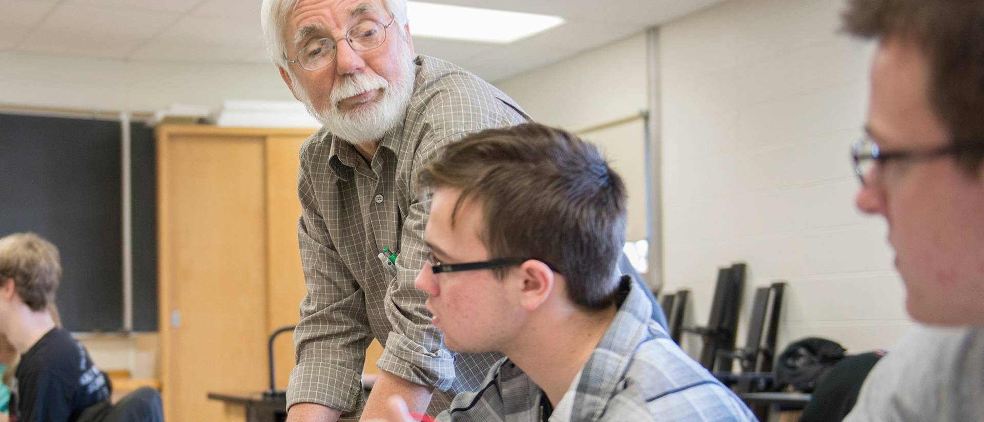 Dr. Thomas Lockhart, UW-Eau Claire professor of physics and astronomy, works in a physics lab with students Tyler Tolan, Eau Claire, and Mathew Guenther, Black River Falls, as they test for the potentials of electric fields using a digital multimeter.