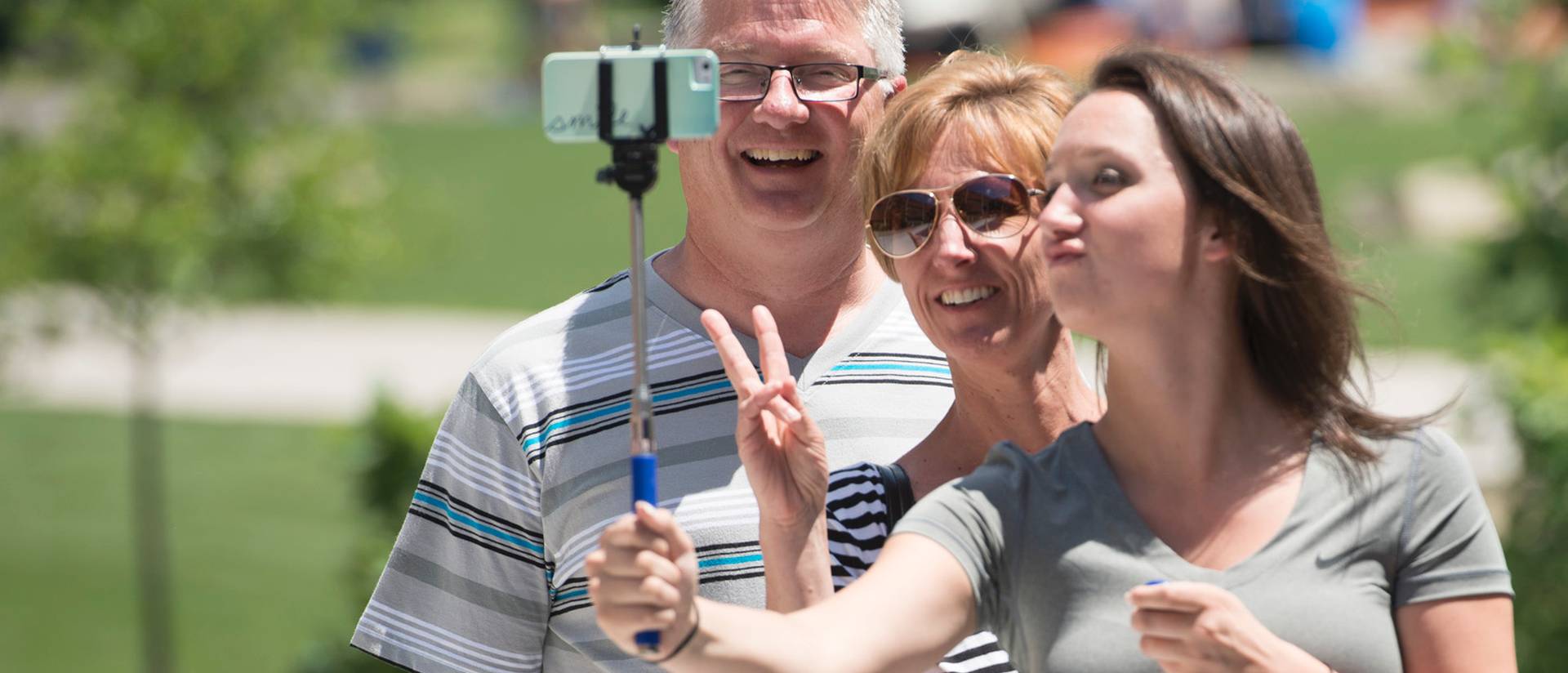 Parents posing for a selfie with their Blugold.