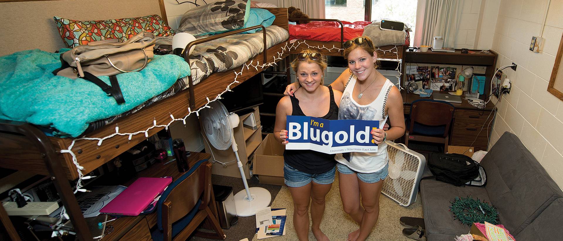 Roommates posing for a picture on move-in day.