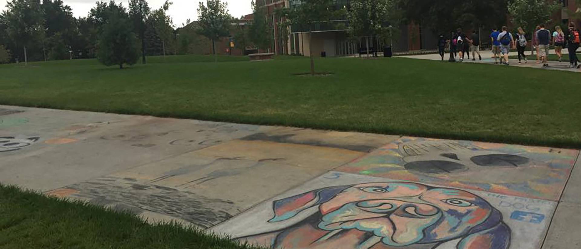 Chalk art on the sidewalks fades away after a week of rain.