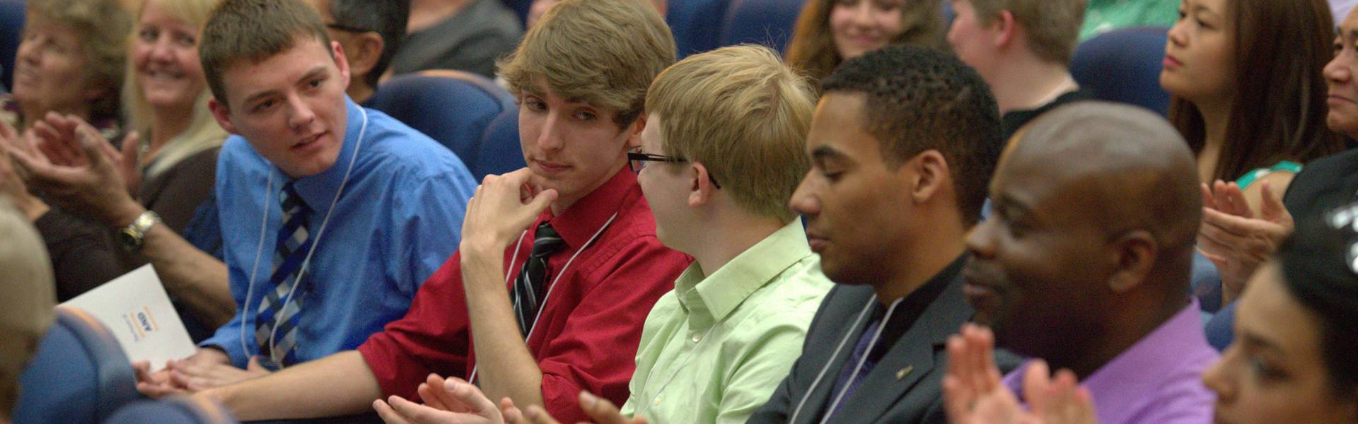 Honors students applaud each other at an awards ceremony