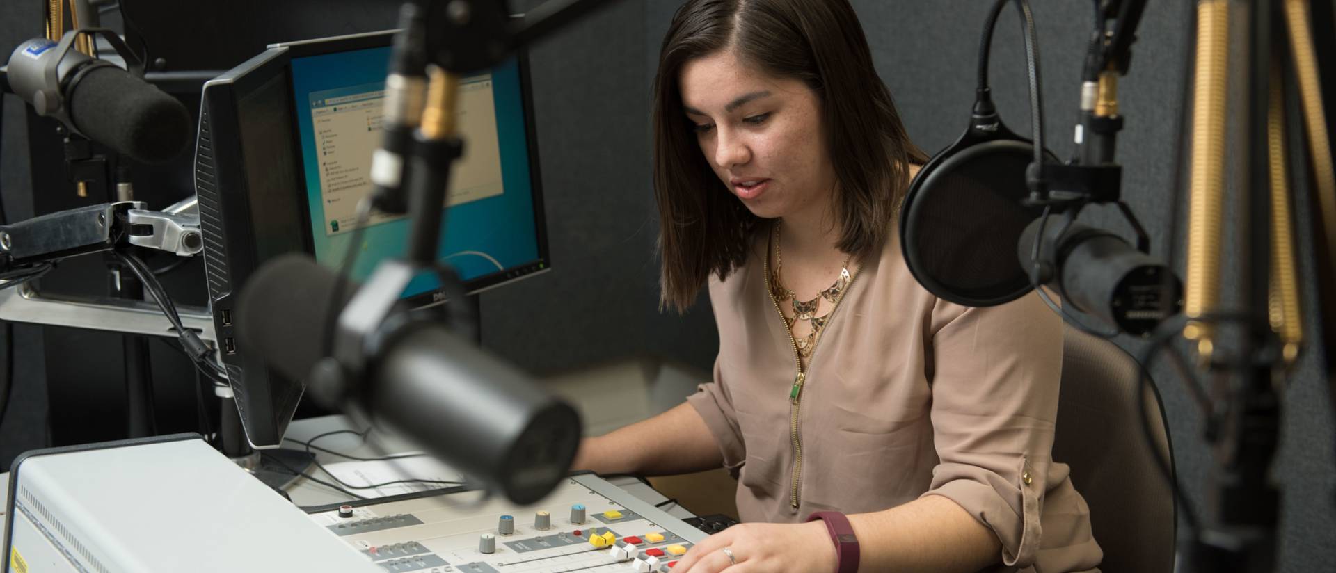 Journalism student in campus radio studio