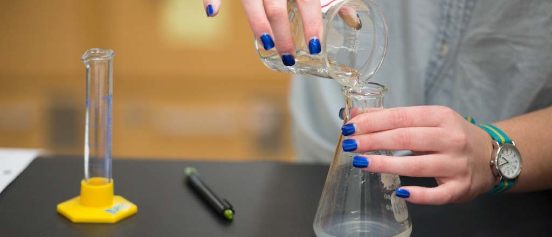 Students using chemistry instruments.