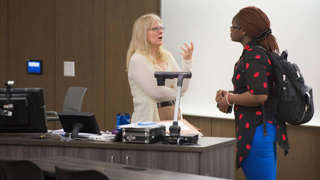 Instructor Patricia Turner talking to student in the classroom