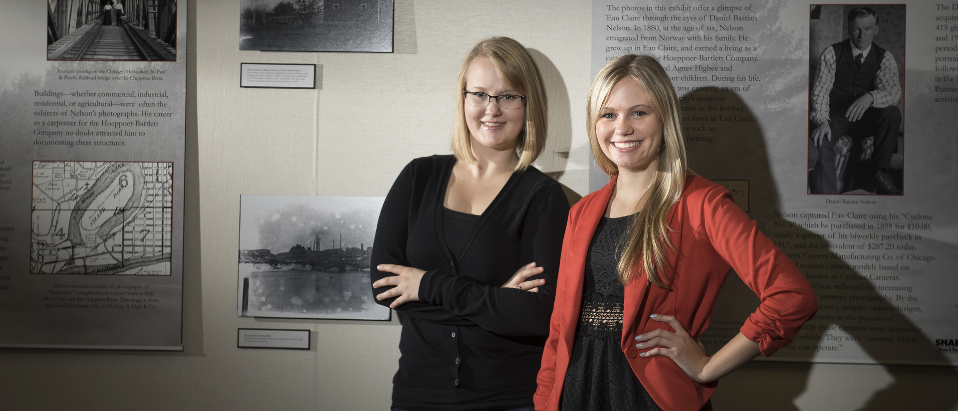 History students Sarah Beer and Makayla Elder with the display of their capstone project "Through Daniel's Eyes"