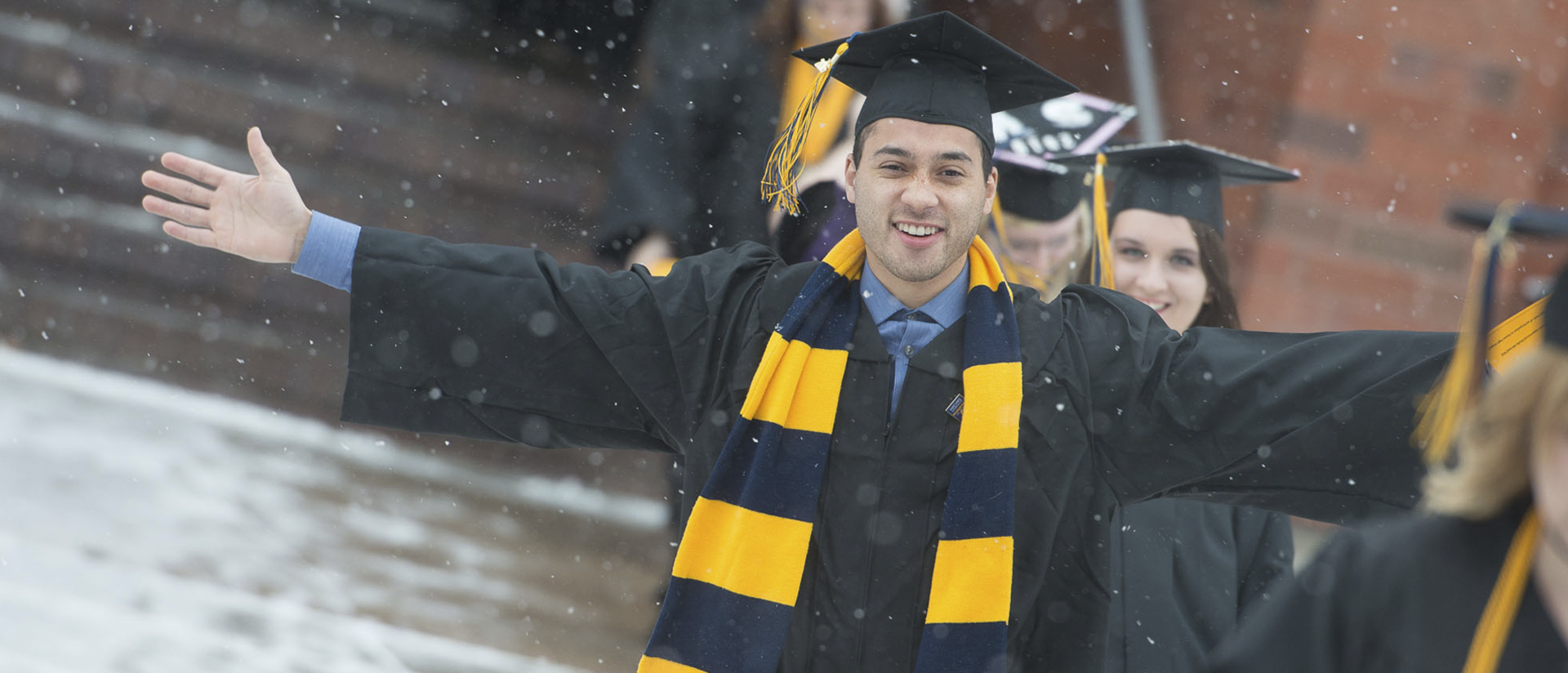 winter commencement graduate in the snow