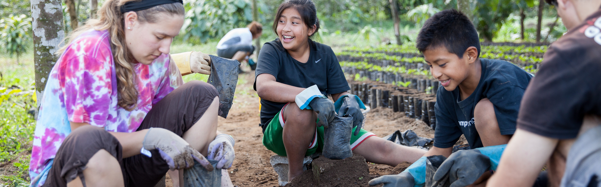 Student on immersion trip planting coffee in Guatemala