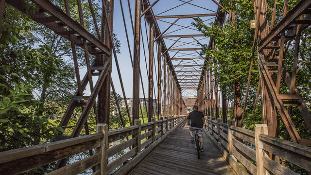 Biker crossing the river on the bridge at Phoenix Park