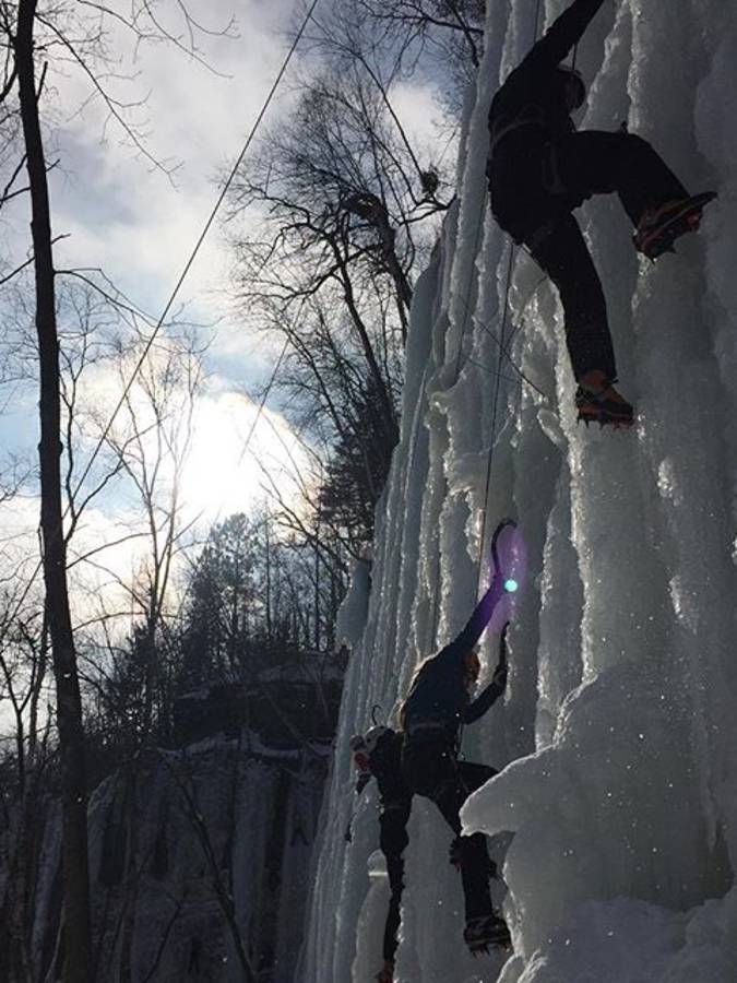 Students scaling an ice wall on winter climbing trip