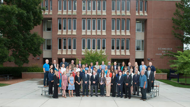University of Wisconsin-Eau Claire College of Business faculty and staff in front of Schneider Hall.
